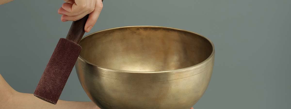 What happens during a singing bowl massage?